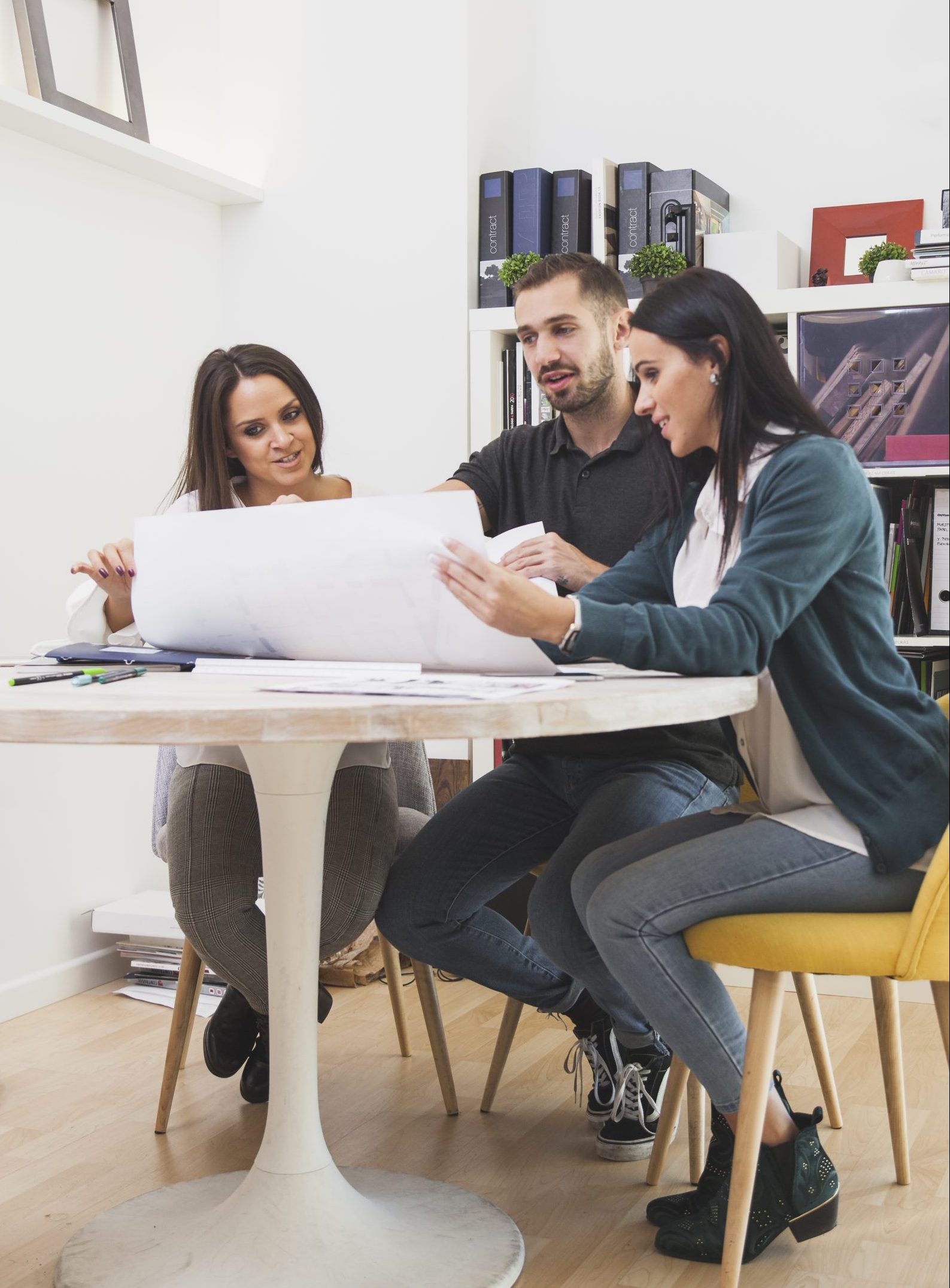 coworkers-sitting-with-blueprint